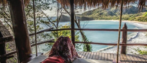 The view from a daybed attached to a bungalow room overlooking the private beach at Morgan’s Rock Hacienda & Eco Lodge on the Pacific Coast