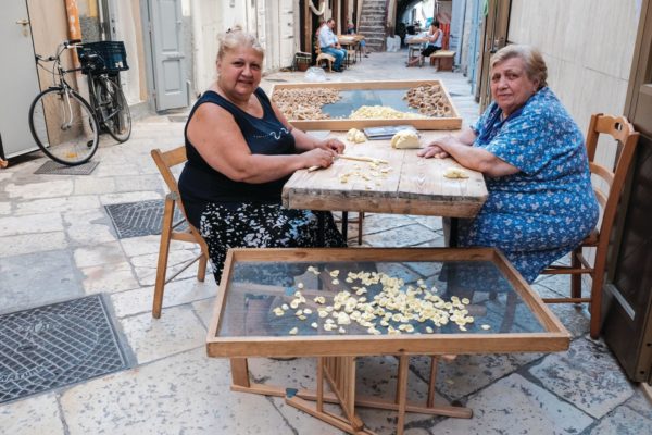 Ladies making orecchiette pasta