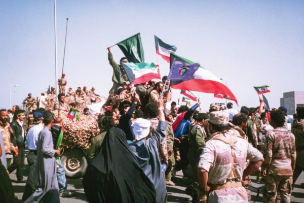 Civilians and coalition military forces celebrate the retreat of Iraqi forces from Kuwait after Operation Desert Storm on 28 February 1991