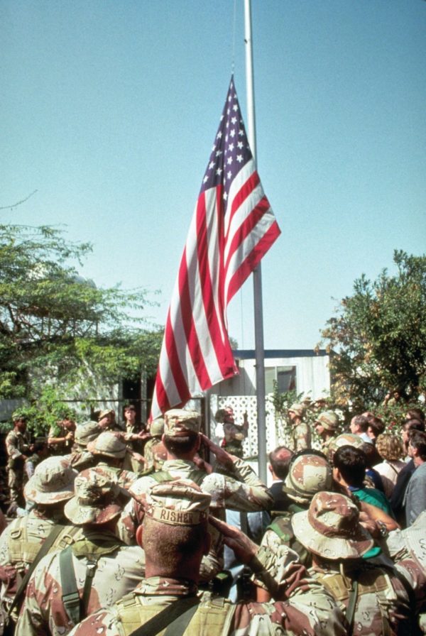 As Iraqi forces retreat from Kuwait, American servicemen raise the flag at the US Embassy
