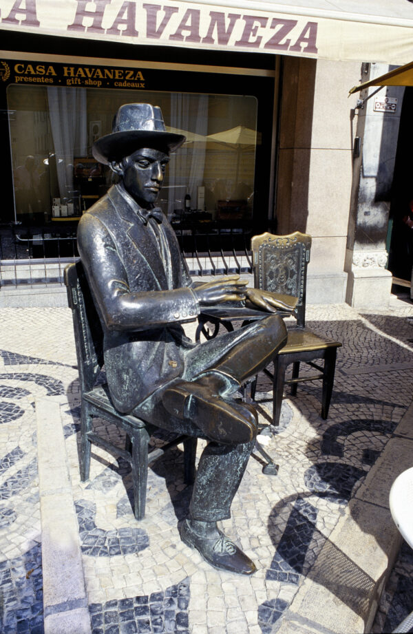 Statue of Fernando Pessoa sits outside the cafe Brasileira in Chiado Lisbon Portugal