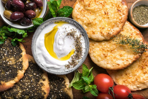 A Lebanese breakfast: labneh, olives, and manakeesh with cheese and zaatar